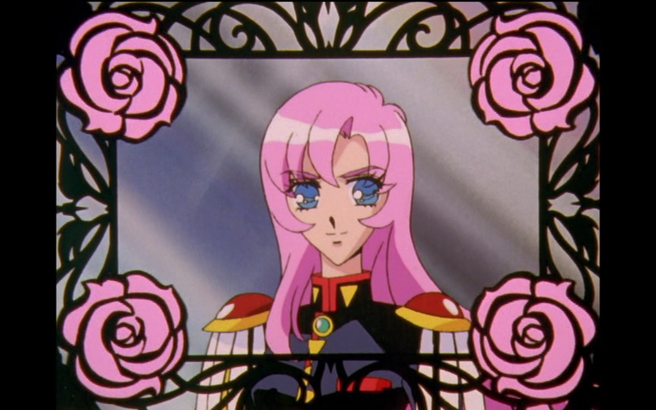 A screencap from Revolutionary Girl Utena. Utena, a teenage girl with long pink hair in a black and red boys' school uniform, shown in profile inside a wrought-iron frame with pink roses in each corner.