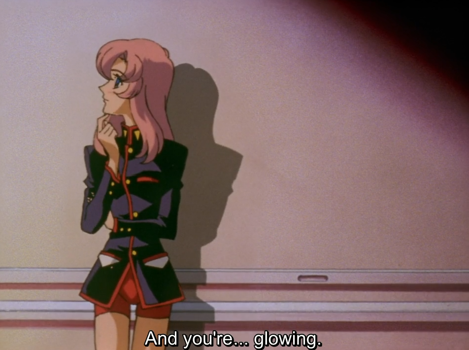 Utena leans against a wall with her hand at her chin, looking off to the side thoughtfully. The subtitle reads “And you’re… glowing.”