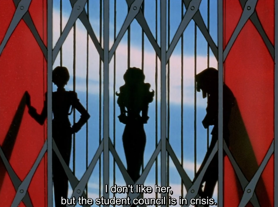 Three student council members shown as black silhouettes behind a grey lattice gate against a pale blue sky, framed by red walls. The subtitle reads “I don’t like her, but the student council is in crisis.”