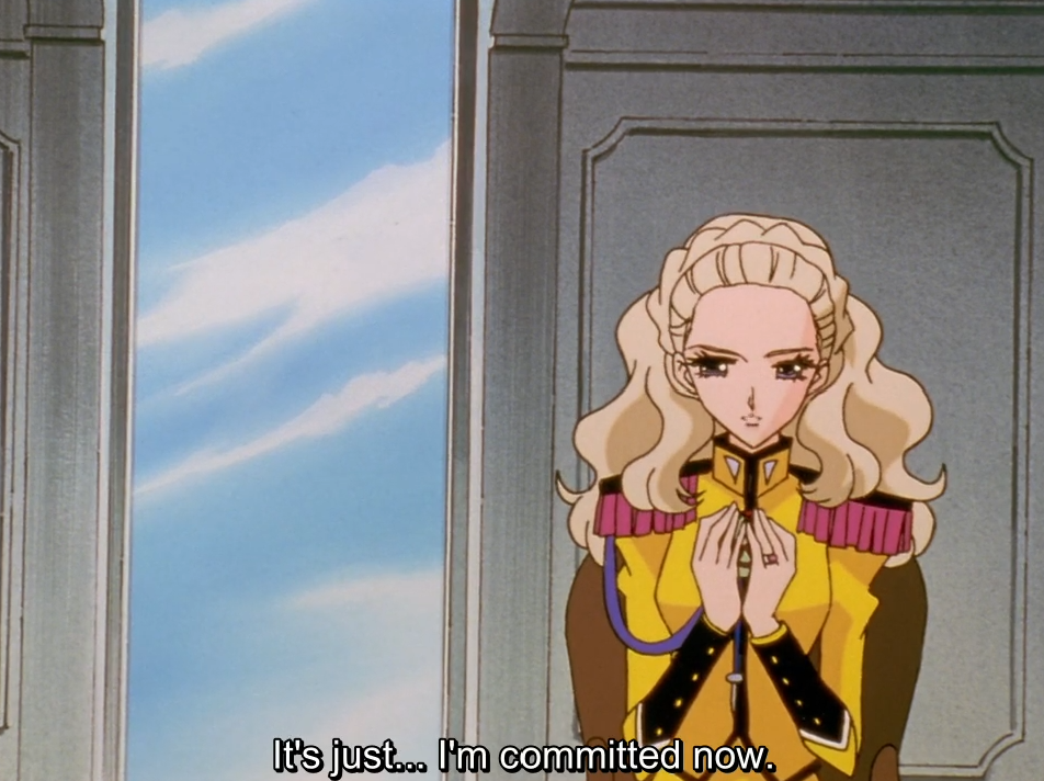 Nanami, in her yellow student council uniform, stands by a window with her hands clasped at her chest. The subtitle reads “It’s just… I’m committed now.”