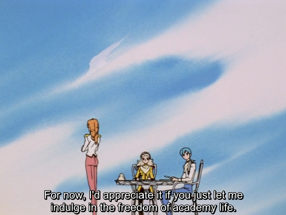 A wide shot under a streaky blue sky: Ruka, with long orange hair, stands with his back to the camera facing Nanami and Miki, who sit at a small table. The subtitle reads “For now, I’d appreciate it if you just let me indulge in the freedom of academy life.”