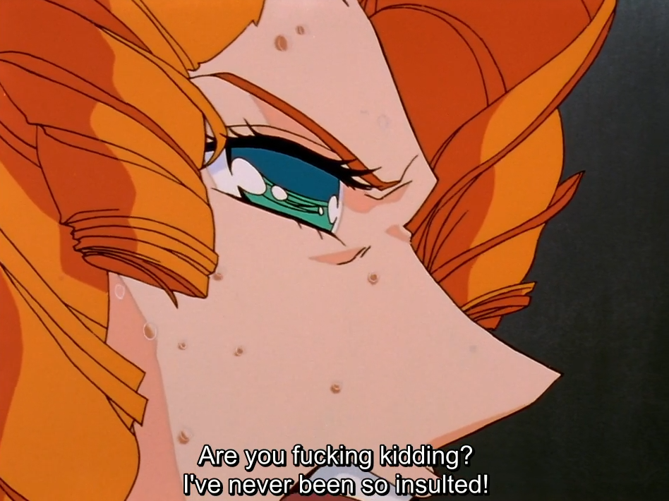 An extreme close-up of Juri’s furious eye, sweat beading on her face. The subtitle reads “Are you fucking kidding? I’ve never been so insulted!”