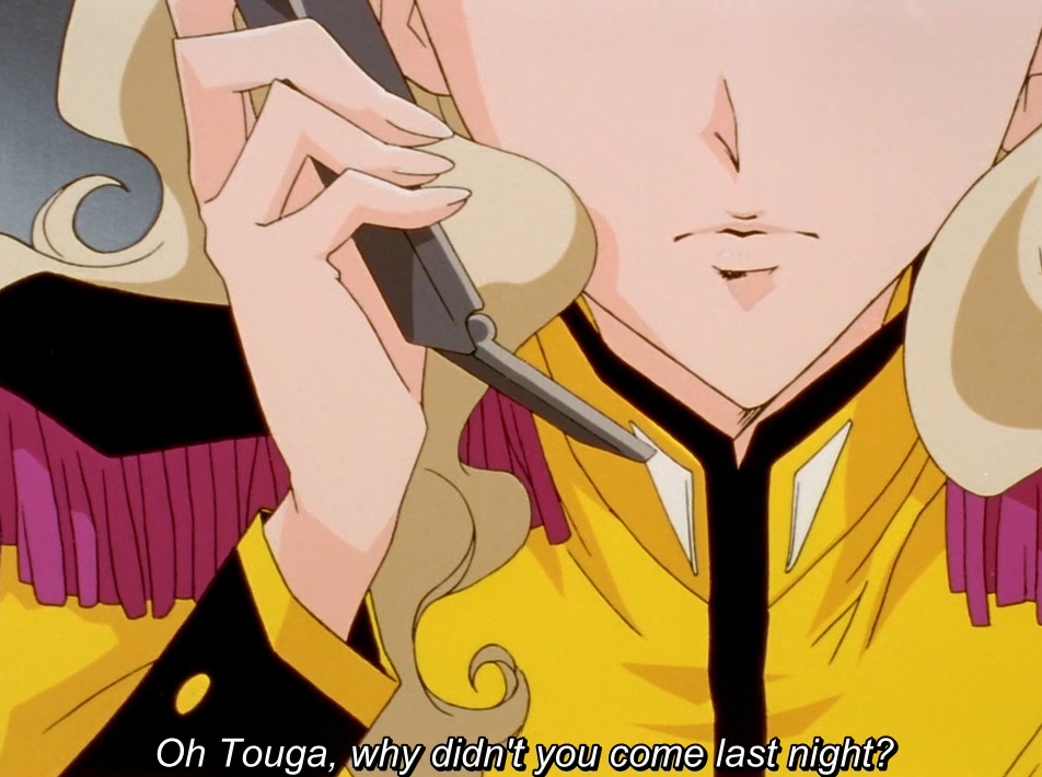 The same close-up of a blonde girl in a yellow uniform holding a phone to her ear, with a different line. The subtitle reads “Oh Touga, why didn’t you come last night?”